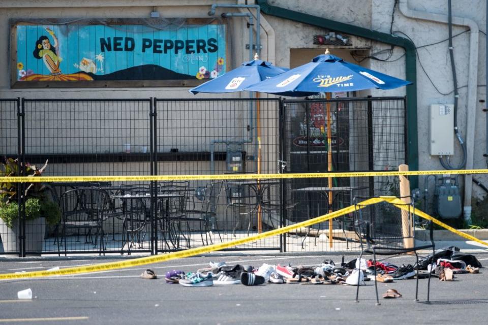 Pairs of shoes are piled behind the Ned Peppers bar belonging to victims of an active shooting that took place in Dayton, Ohio on August 04, 2019. | Megan Jelinger—AFP/Getty Images