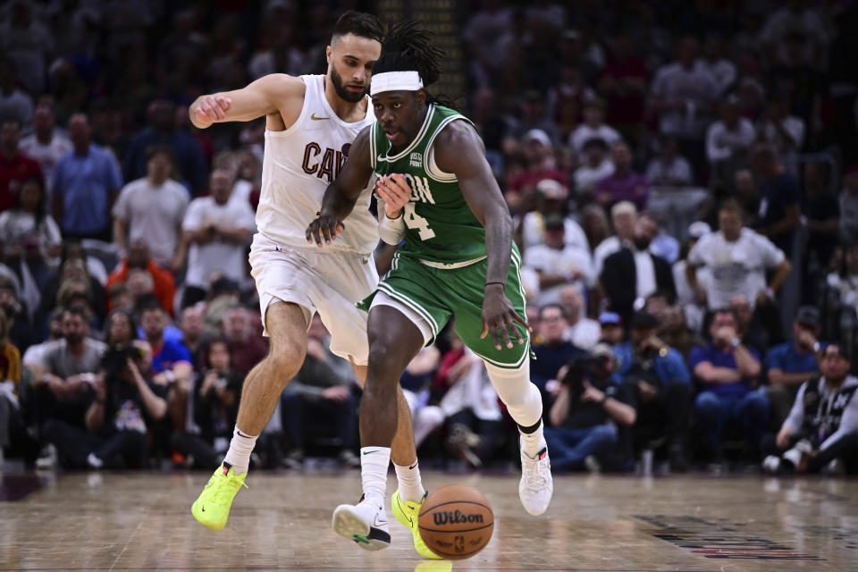 Boston Celtics guard Jrue Holiday (4) drives against Cleveland Cavaliers guard Max Strus, left, during the second half of Game 4 of an NBA basketball second-round playoff series, Monday, May 13, 2024, in Cleveland. (AP Photo/David Dermer)