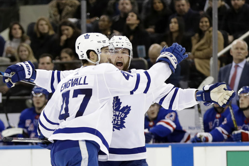 Toronto Maple Leafs' Pierre Engvall (47) celebrates with Jake Muzzin after scoring a goal during the first period of an NHL hockey game against the New York Rangers, Friday, Dec. 20, 2019, in New York. (AP Photo/Frank Franklin II)