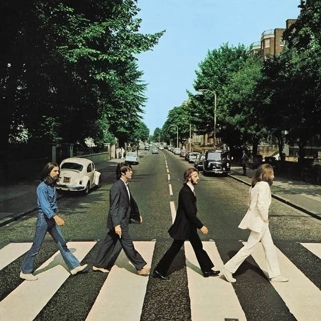 The Beatles' famous Abbey Road album as the band members walk across a cross walk in single line formation