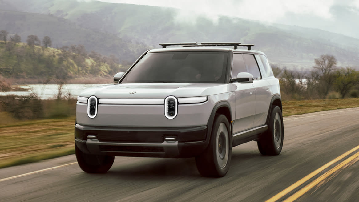  The Rivian R2 EV speeding down a road. 