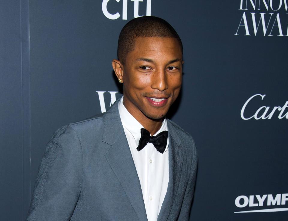 FILE - In this Nov. 6, 2013 file photo, Pharrell Williams attends the WSJ. Magazine's Innovator Awards in New York. This week Pharrell released his sophomore solo album, “G I R L,” which features the Oscar-nominated hit, “Happy.” The song is spending its second week on top of the Billboard Hot 100 chart. (Photo by Charles Sykes/Invision/AP, File)