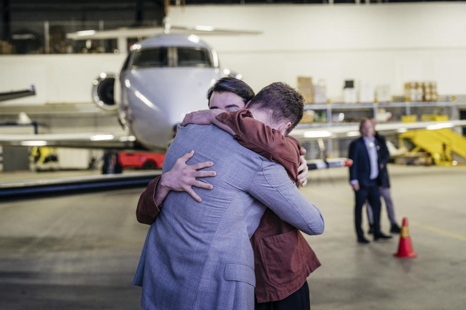 In this photo provided by the Swedish government, Johan Floderus reunites with his family at Arlanda airport in Stockholm, Sweden on Saturday, June 15, 2024, after being released from prison in Iran. (Tom Samuelsson/Swedish government/TT News Agency via AP)