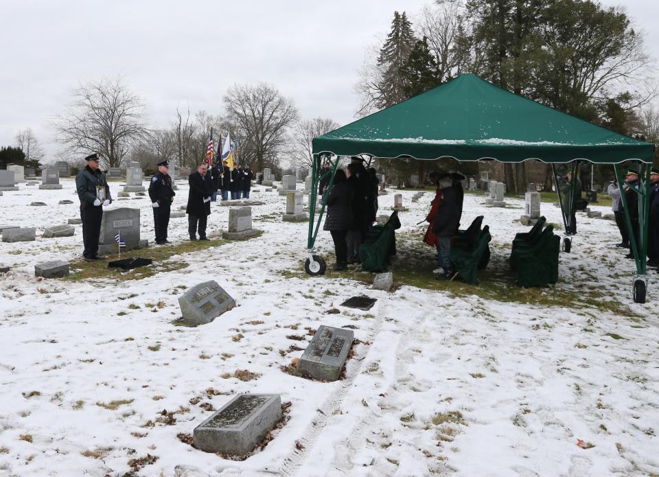 The South Bend Police Department Honor Guard takes part Wednesday, Jan. 10, 2024, at the grave marker dedication service for South Bend Police Officer Fred E. Buhland, who died in the line of duty 103 years ago — on Jan. 10, 1921 — and had been buried in an unmarked grave in Highland Cemetery.