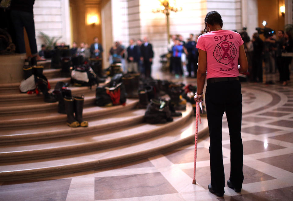 SAN FRANCISCO, CA - MARCH 26:  Former San Francisco firefighter and cancer survivor Denise Elarms waits to speak during a remembrance ceremony held for San Francisco firefighters who have died of cancer on March 26, 2014 in San Francisco, California. Over two hundred pairs of boots were displayed on the steps inside San Francisco City Hall to symbolize the 230 San Francisco firefighters who have died of cancer over the past decade. According to a study published by the National Institute for Occupational Safety and Health, (NIOSH)  findings indicate a direct correlation between exposure to carcinogens like flame retardants and higher rate of cancer among firefighters. The study showed elevated rates of respiratory, digestive and urinary systems cancer and also revealed that participants in the study had high risk of mesothelioma, a cancer associated with asbestos exposure. (Photo by Justin Sullivan/Getty Images)