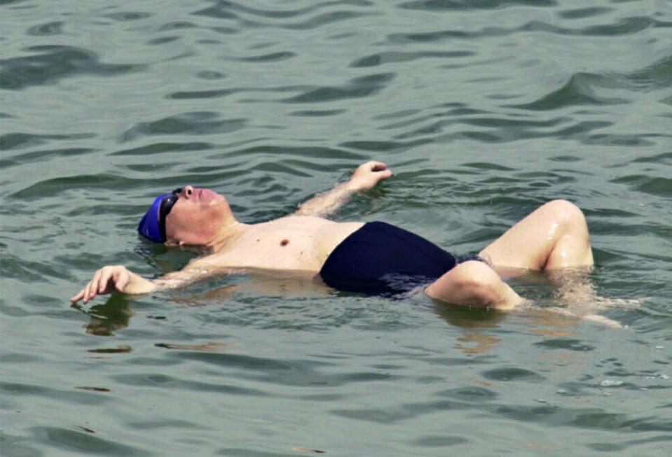 FILE - Chinese President Jiang Zemin floats on Dead Sea near Ein Bokek, Israel, April 14, 2000. Chinese state TV said Wednesday, Nov. 30, 2022, that Jiang has died at age 96. (AP Photo/Lefteris Pitarakis, File)