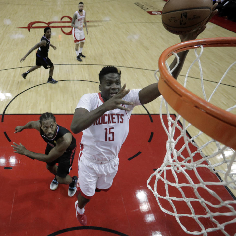 Houston Rockets' Clint Capela (15) shoots as LA Clippers' Kawhi Leonard defends during the first half of an NBA basketball game Wednesday, Nov. 13, 2019, in Houston. (AP Photo/David J. Phillip)