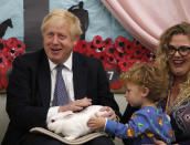 FILE - In this Thursday, Nov. 14, 2019 file photo Britain's Prime Minister Boris Johnson hold Rosie the rabbit during a visit of the West Monkton CEVC Primary School on a General Election campaign trail in Taunton, England. (AP Photo/Frank Augstein, Pool, File)