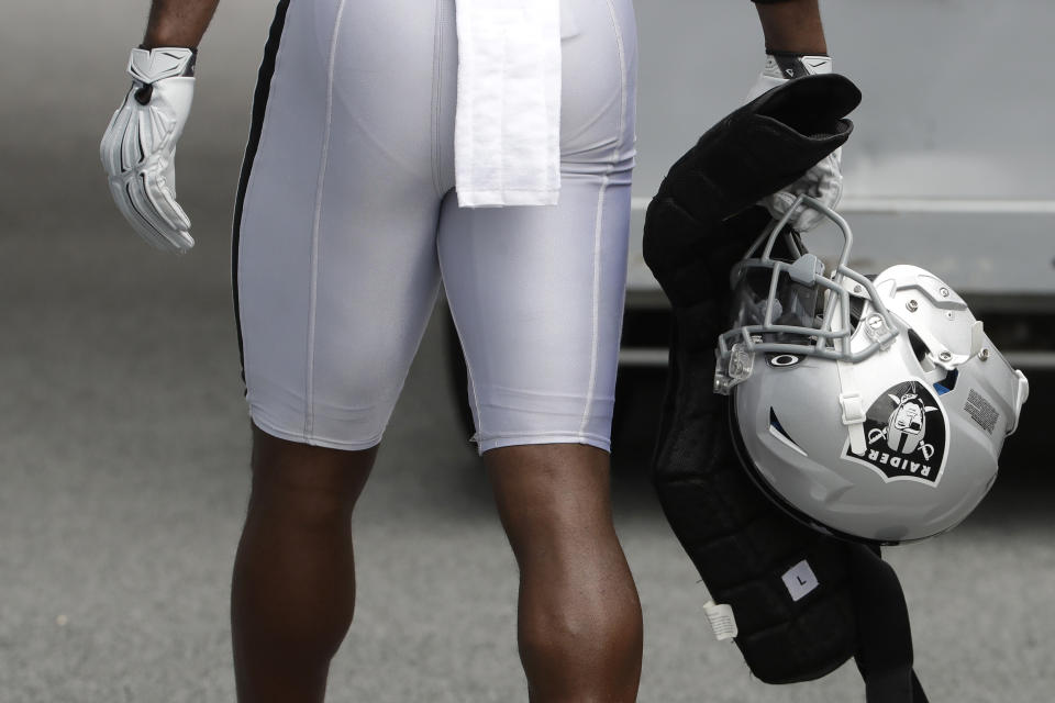 Oakland Raiders' Antonio Brown carries his helmet as he walks off the field after practice on Tuesday. (AP)