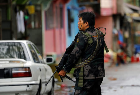 A government soldier takes up position during a patrol along a deserted street in Marawi City, southern Philippines May 27, 2017. REUTERS/Erik De Castro