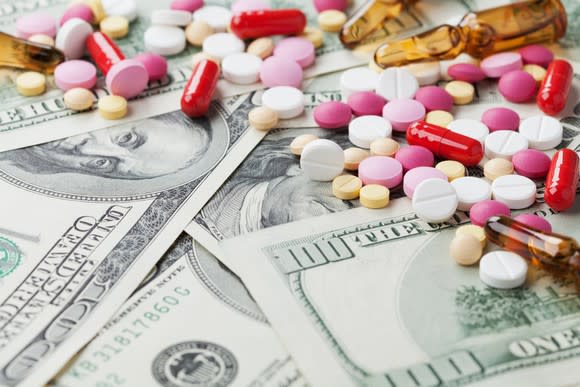 Pills lying on top of cash.