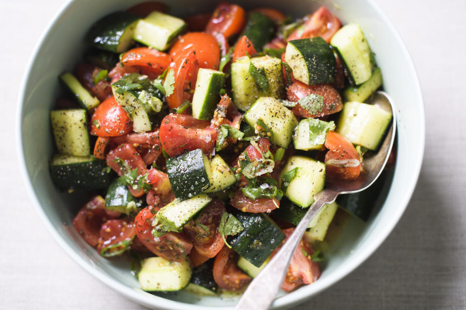 This image released by Milk Street shows a recipe for tomato and cucumber salad with capers and feta. (Milk Street via AP)