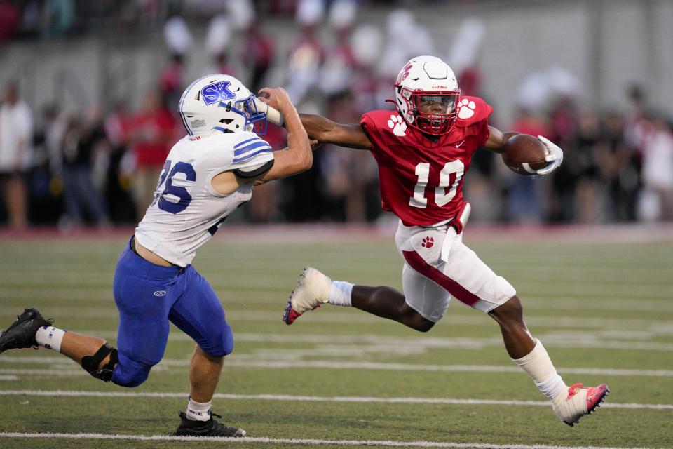 Beechwood's Antonio Robinson Jr. (10) breaks a tackle by Simon Kenton's Julian Robles (26) during a KHSAA high school football game at Beechwood High School Friday, Sept. 9, 2022, in Fort Mitchell, Ky.
