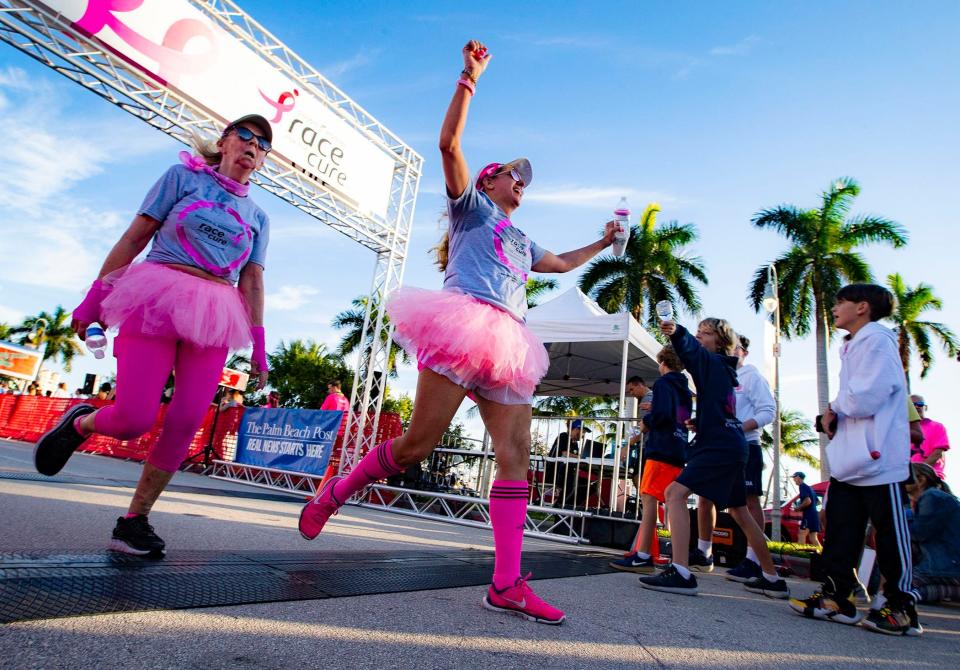 Tracy Channing, (right) Wellington, crosses the finish line with Tanice Speziale, Coconut Creek, during the 5K 2020 Komen South Florida Race for the Cure in West Palm Beach, Saturday, Jan. 25, 2020. [ALLEN EYESTONE/palmbeachpost.com]
