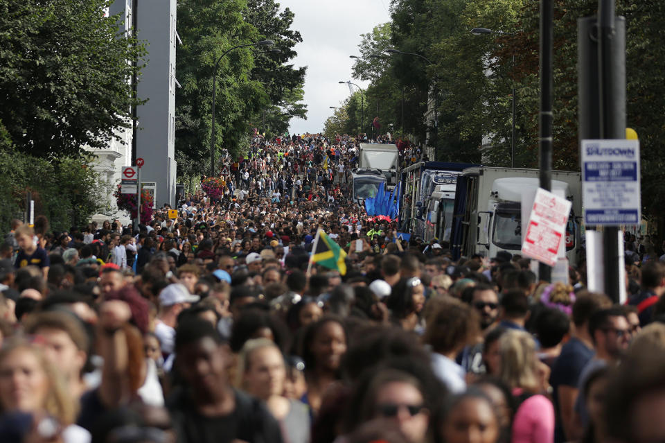 <p>Revellers line the streets on the first day of the Notting Hill Carnival in west London on August 28, 2016. (Photo: DANIEL LEAL-OLIVAS/AFP/Getty Images) </p>