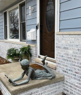 This little bronze statue, purchased on Saturday, January 7, 2023  from an estate sale in Port Huron, now lives on the porch of Free Press reporter Phoebe Wall Howard.