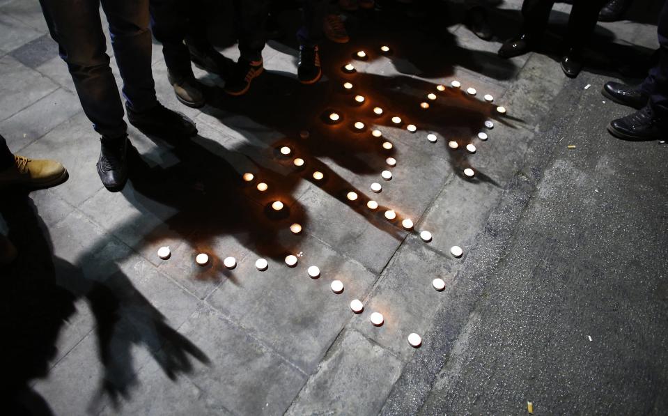 People gather round candles as they celebrate in Ankara