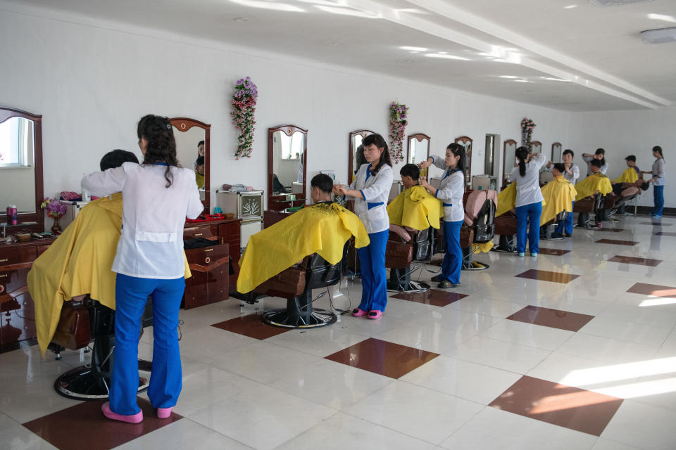 Workers have their hair cut in a salon at Hungnam Fertilizer Complex on Feb. 4, in Hamhung, North Korea.