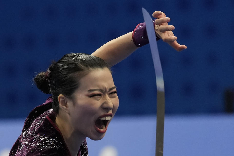 Hong Kong's He Jianxin performs at the Wushu Women's Nandao competition for the 19th Asian Games in Hangzhou, China, Tuesday, Sept. 26, 2023. (AP Photo/Ng Han Guan)