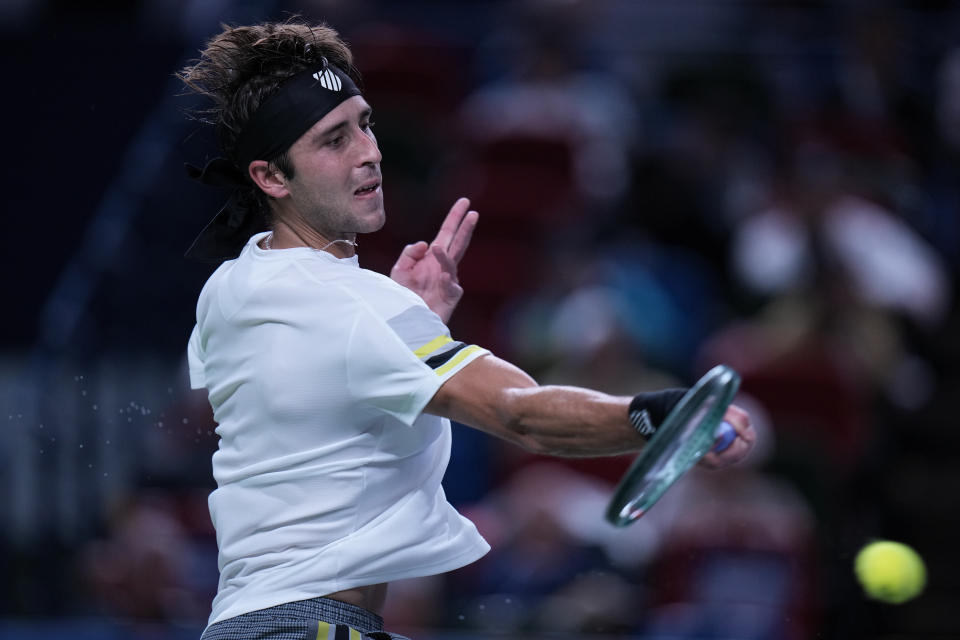 Tomas Martin Etcheverry of Argentina returns a forehand shot to Jannik Sinner of Italy during the men's singles match in the Shanghai Masters tennis tournament at Qizhong Forest Sports City Tennis Center in Shanghai, China, Sunday, Oct. 6, 2024. (AP Photo/Andy Wong)