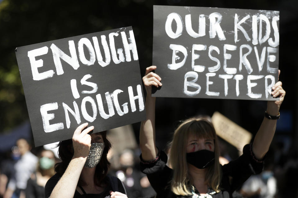 Thousands of people with placards and banners rally demanding justice for women in Sydney, Monday, March 15, 2021, as the government reels from two separate allegations. The rally was one of several across Australia including in Canberra, Melbourne, Brisbane and Hobart calling out sexism, misogyny and dangerous workplace cultures. (AP Photo/Rick Rycroft)