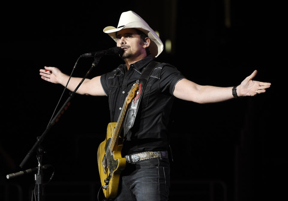 FILE - This Jan. 25, 2018 file photo shows Brad Paisley performing during his Weekend Warrior World Tour in Los Angeles. Paisley released a new single, “No I in Beer,” and has been surprising people on video calls to share in a virtual happy hour. Led by the chorus, “We're all in this together,” the song sends a toast to frontline workers in the global pandemic, including nurses, first responders and farmers. (Photo by Chris Pizzello/Invision/AP, File)