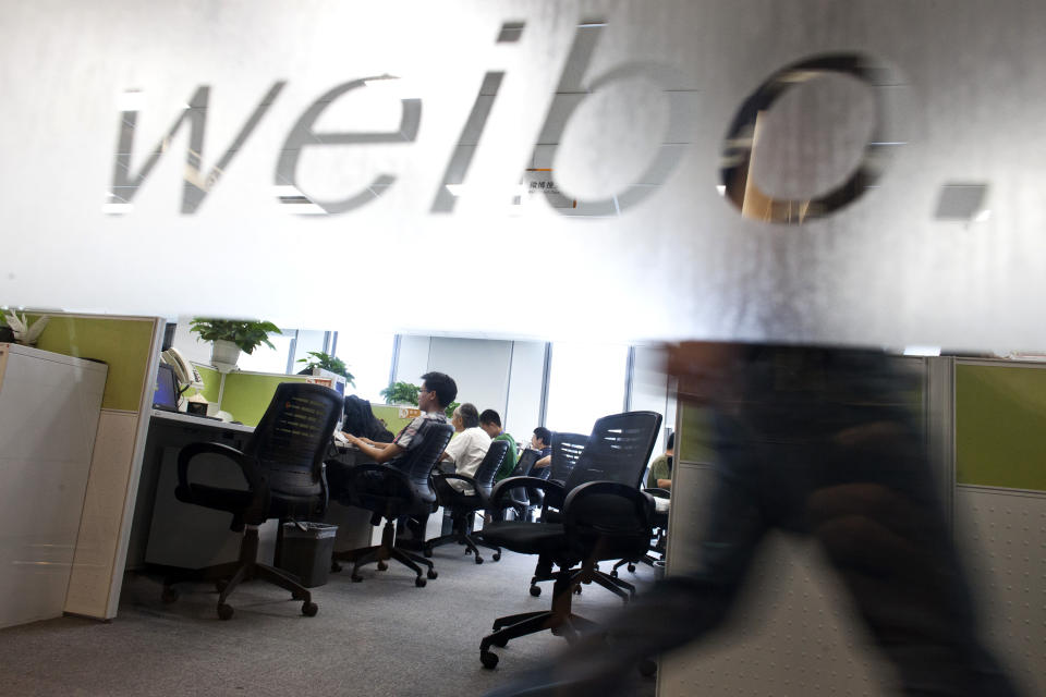 In this photo taken on Aug. 1, 2012, employees work at their desks at a Sina Weibo office in Beijing. Launched in 2009, China's leading microblog site, Sina Weibo, gave a digital megaphone to more than 300 million Chinese, prompting many to wonder if it might drive Arab Spring-style political change and democratic reforms. (AP Photo/Alexander F. Yuan)