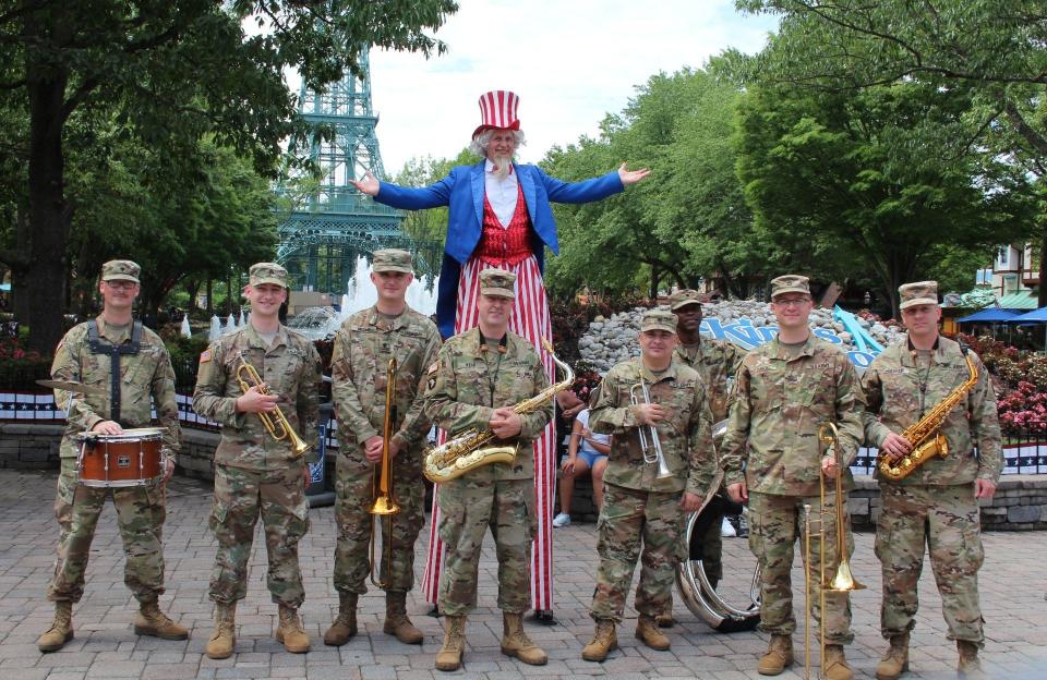 The 380th Army Band poses with Uncle Sam and instruments at the main entrance of Kings Dominion in Doswell, Virginia.