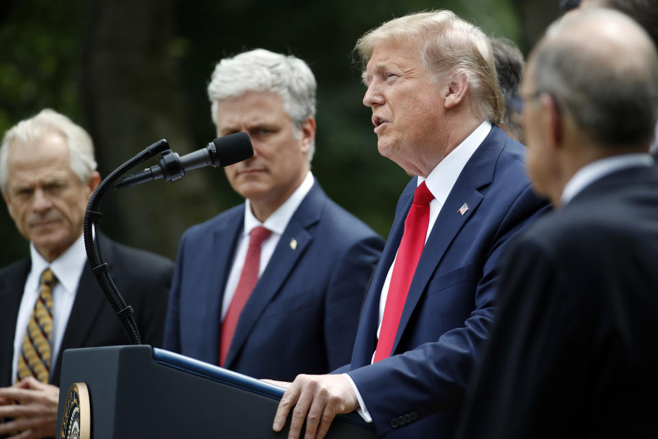 President Donald Trump speaks in the Rose Garden of the White House, Friday, May 29, 2020, in Washington, As White House trade adviser Peter Navarro, left, White House national security adviser Robert O'Brien, and White House chief economic adviser Larry Kudlow, far right, listen. (AP Photo/Alex Brandon)