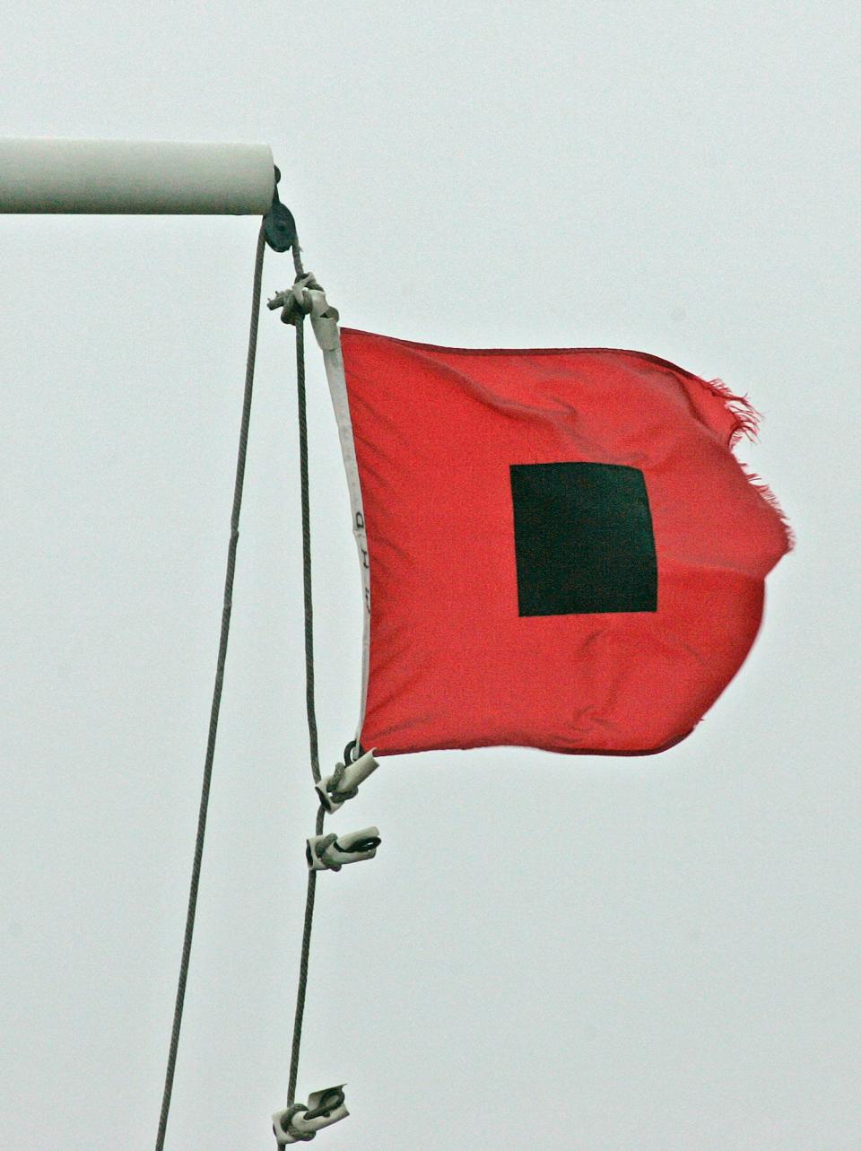 A hurricane warning flag goes up to indicate winds in the range of 55-73 mph.