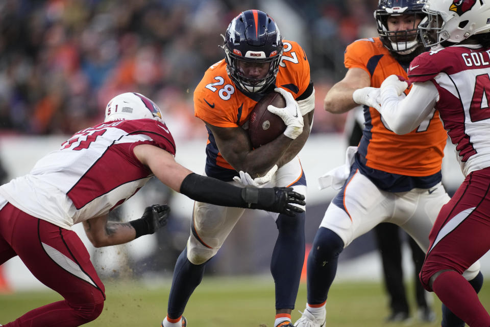 Denver Broncos running back Latavius Murray (28) runs as Arizona Cardinals linebacker Tanner Vallejo, left, defends during the second half of an NFL football game, Sunday, Dec. 18, 2022, in Denver. (AP Photo/David Zalubowski)