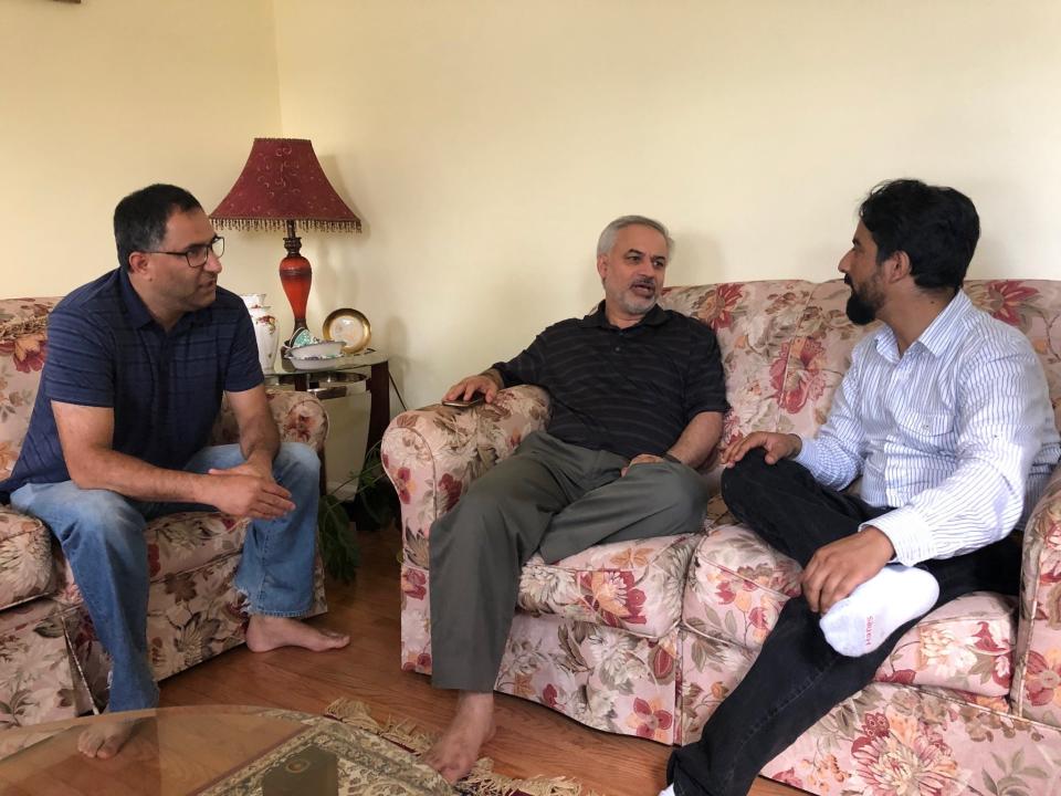 Tahir Qazi (middle) chats with friends, Arif Jan (left) and Shuaib Nabi (right) during Ramadan 2019.