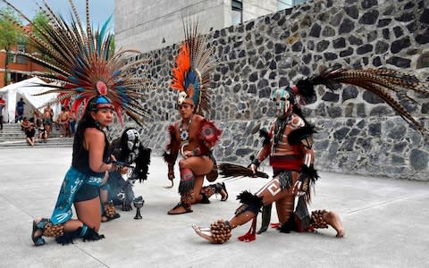 Dancers perform ahead of a pre-Columbian ballgame called "Ulama"  - Credit: AFP