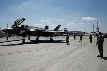 FILE PHOTO: U.S. soldiers stand guard as a Lockheed Martin F-35 Lightning II aircraft is moved on the eve of the 52nd Paris Air Show at Le Bourget Airport near Paris, France June 18, 2017. REUTERS/Pascal Rossignol/File Photo