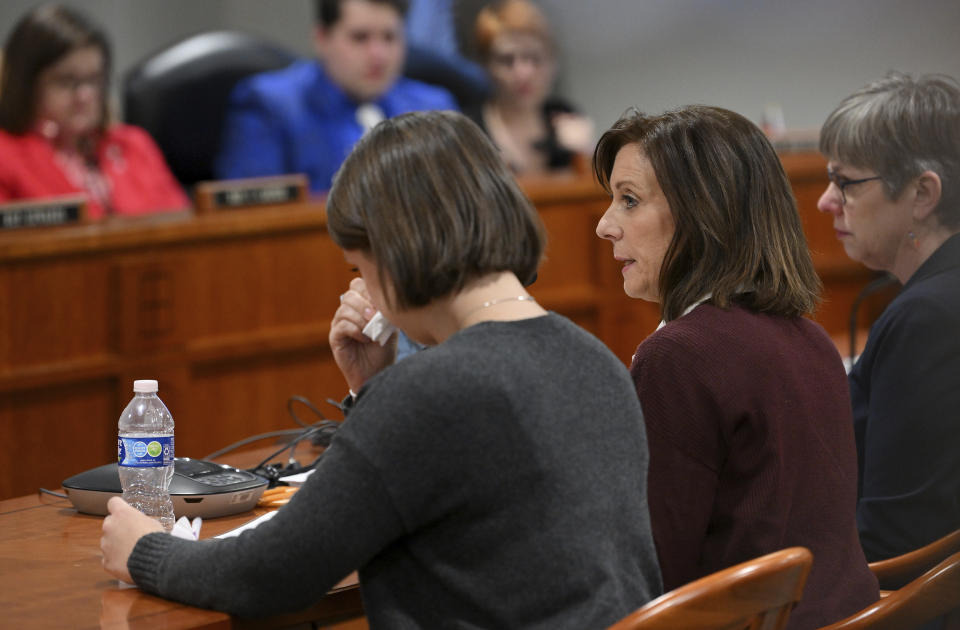 From left, Sloan Forbush listens as her mother, Krista Grettenbeerger, mother of Michigan State University shooting survivor Troy Forbush, gives testimony at the House Judicial Committee hearing at the House Office Building in Lansing, Mich., on Wednesday, Mar. 8, 2023. Michigan Democrats are poised to bring an 11-bill package to the Legislature next week that would implement safe storage laws, universal background checks and extreme risk protection orders, also known as red flag laws. A February mass shooting at MSU pushed Democrats to act fast on legislation they had already planned to prioritize. (Robin Buckson/Detroit News via AP)