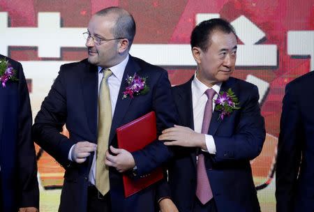 FIBA Secretary General Patrick Baumann and Wang Jianlin (R), chairman of the Wanda Group, attend a signing ceremony in Beijing, China June 16, 2016. REUTERS/Jason Lee