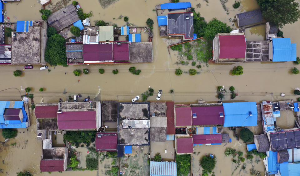 FILE - In this July 20, 2020, aerial file photo released by Xinhua News Agency shows the extent of flooding in Guzhen Town of Lu'an City in eastern China's Anhui Province. Summer floods in China have left more than 200 people dead or missing and caused $25 billion in direct damages, an emergency management official said Thursday, Aug. 13, 2020. The floods struck major river systems across the central and southern parts of the country. (Tang Yang/Xinhua via AP, File)