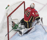 Calgary Flames goalie Cam Talbot (39) sits on Dallas Stars' Jason Dickinson (18) in the net during the second period in the first round NHL Stanley Cup playoff hockey series, Friday, Aug. 14, 2020, in Edmonton, Alberta. (Jason Franson/The Canadian Press via AP)