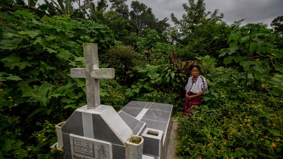 Guatemalan women stands by grave