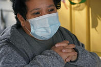 Evelyn Maysonet, 53, looks on as food is provided by Weber-Morgan Health Department Tuesday, Nov. 24, 2020, in Ogden, Utah. Maysonet has been isolating with her husband and son in their Ogden home since all three tested positive for COVID-19 over a week ago. None of them have been able to leave home to buy groceries so Maysonet said they were thrilled to receive the health department's delivery. (AP Photo/Rick Bowmer)