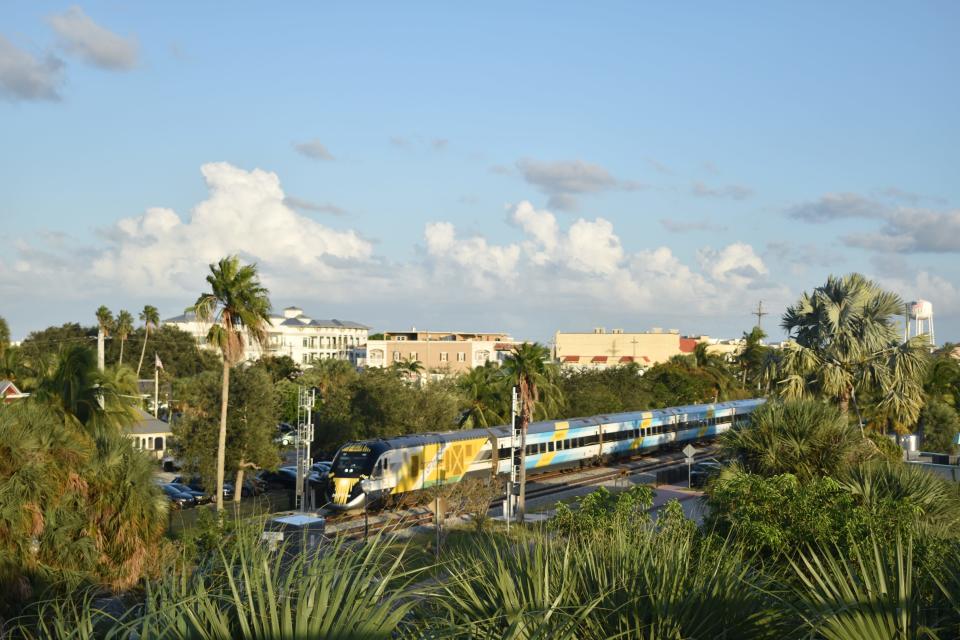 A Brightline train seen from the Roosevelt Bridge in Stuart travels north through downtown Stuart its first day of carrying passengers to Orlando Sept. 23, 2023.