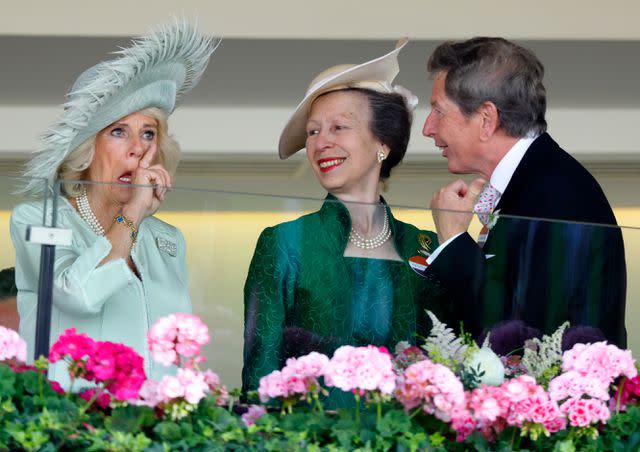 <p>Max Mumby/Indigo/Getty</p> Queen Camilla wipes a tear as Princess Anne and John Warren reassure her with a smile at the 2023 Royal Ascot.