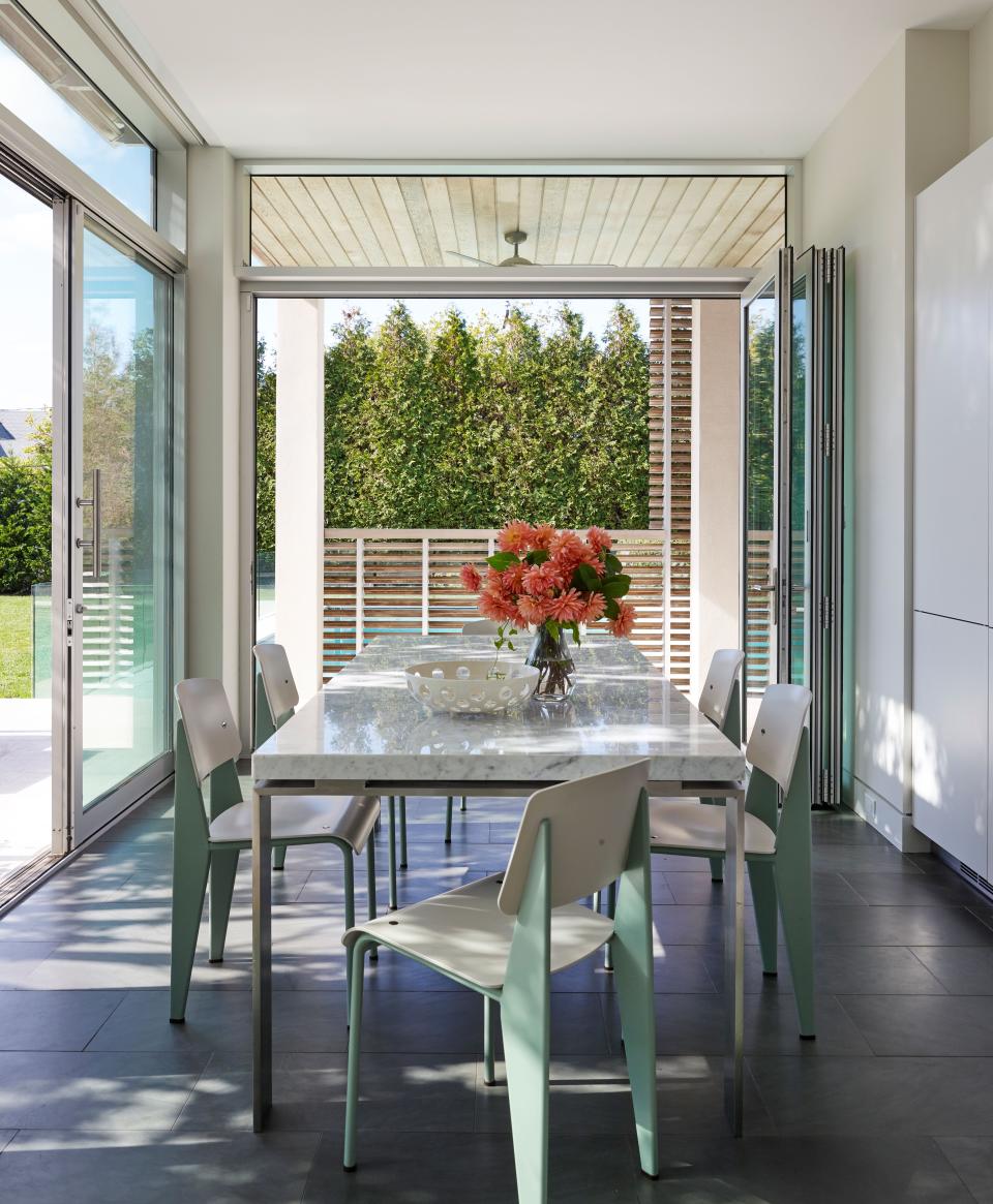 The clients added a patio so that the breakfast nook would have easy outdoor access. The custom dining table is by James Devlin.