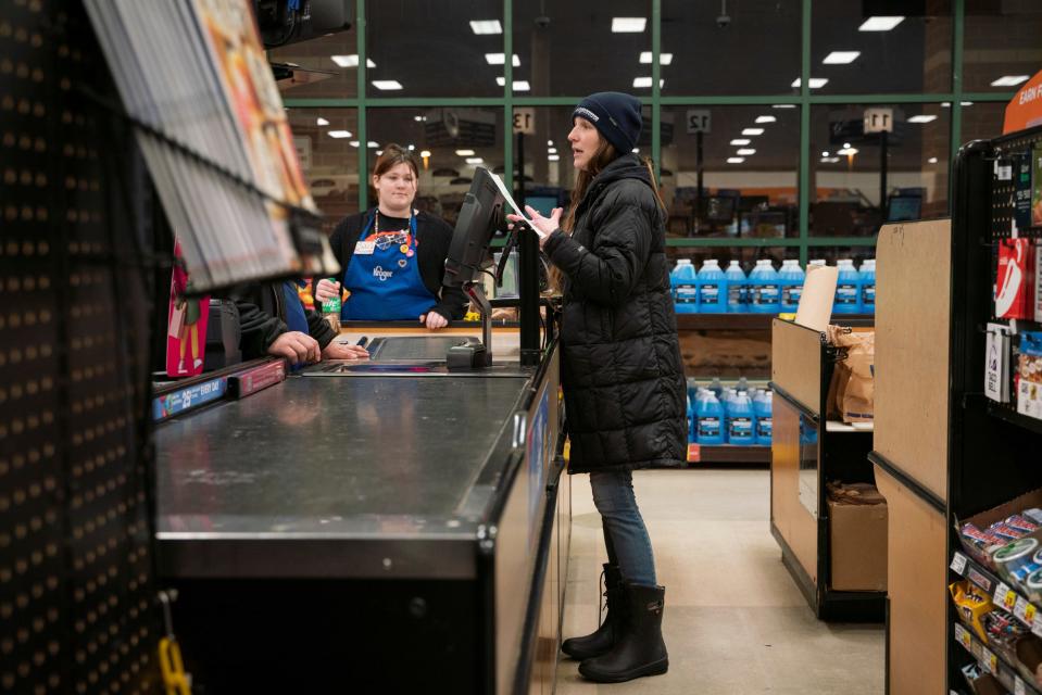 Lighthouse housing programs lead Brianna Agnello, 37, talks with Kroger employees in hopes of identifying people experiencing homelessness during the annual Point-in-Time (PIT) count in Troy on Jan. 30, 2023.