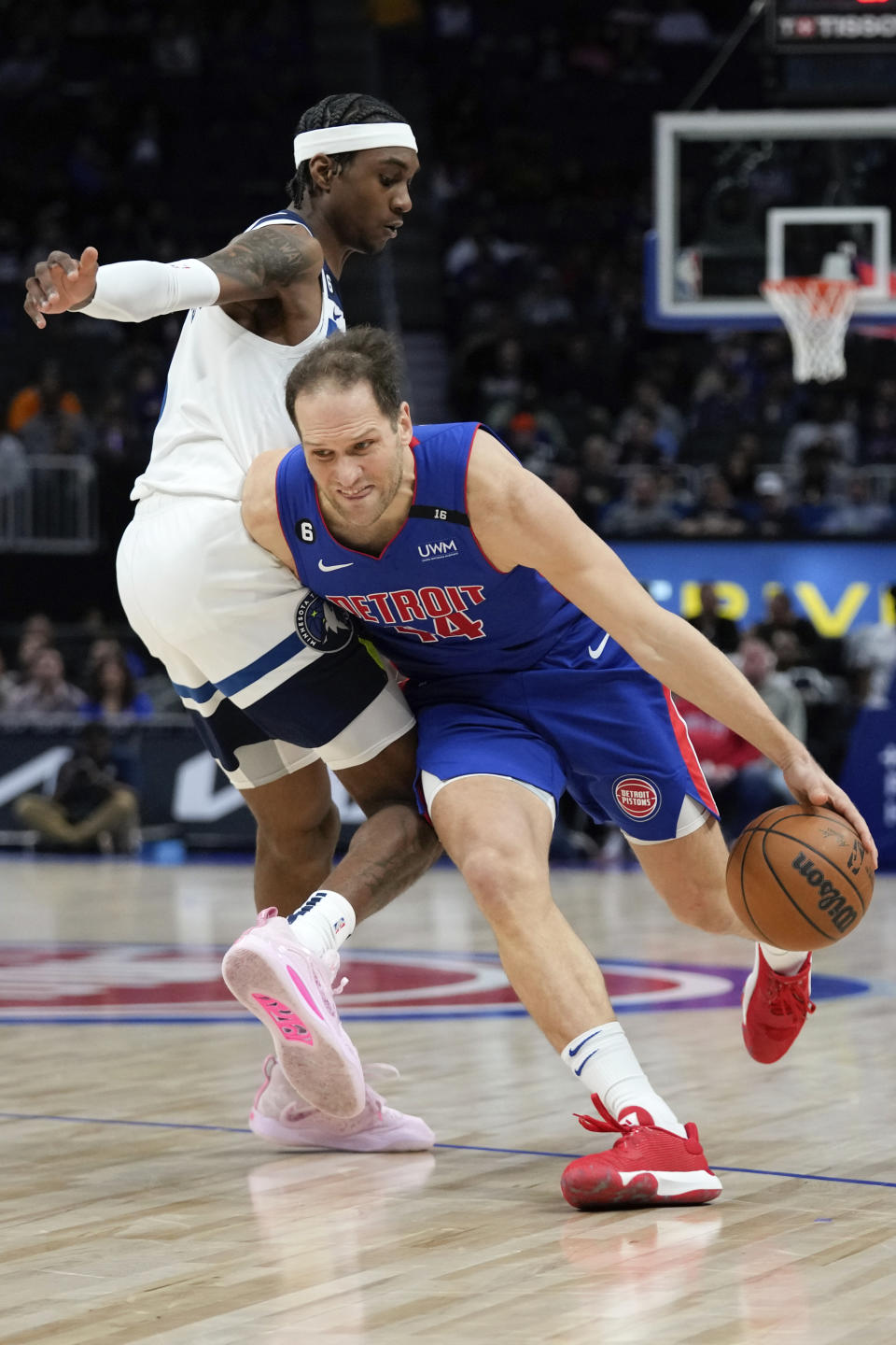 Detroit Pistons forward Bojan Bogdanovic (44) drives on Minnesota Timberwolves forward Jaden McDaniels (3) in the first half of an NBA basketball game in Detroit, Wednesday, Jan. 11, 2023. (AP Photo/Paul Sancya)