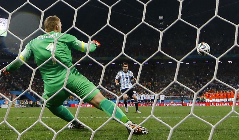 Argentina's Messi shoots to score his penalty past Cillessen of the Netherlands during their shootout in their 2014 World Cup semi-finals at the Corinthians arena in Sao Paulo