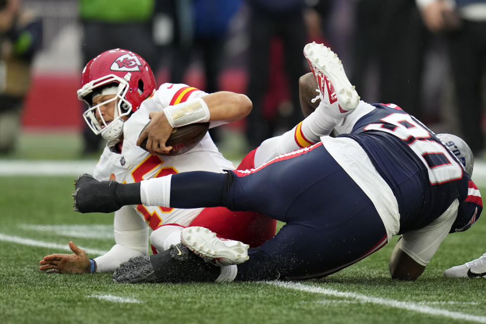 Kansas City Chiefs quarterback Patrick Mahomes, left, is sacked by New England Patriots defensive tackle Christian Barmore, right, during the first half of an NFL football game, Sunday, Dec. 17, 2023, in Foxborough, Mass. (AP Photo/Charles Krupa)