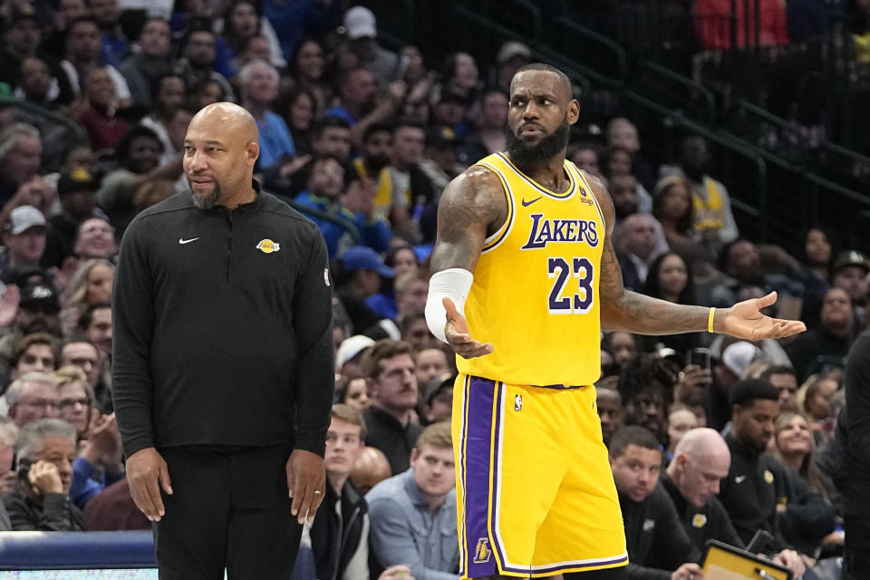 Los Angeles Lakers forward LeBron James (23) reacts to a call as head coach Darvin Ham looks on during the first half of an NBA basketball game against the Dallas Mavericks in Dallas, Tuesday, Dec. 12, 2023. (AP Photo/LM Otero)