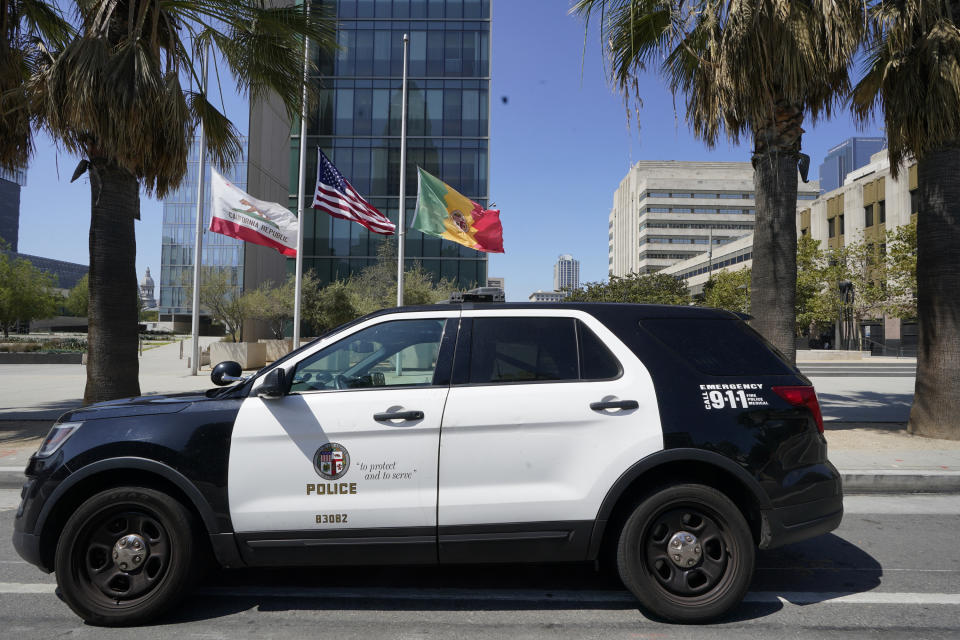 FILE - A Los Angeles Police Department vehicle is parked outside the LAPD headquarters downtown Los Angeles Friday, July 8, 2022. The Los Angeles police chief and the department's constitutional policing director are under investigation after the names and photographs of undercover officers were released to a technology watchdog group that posted them online, the Los Angeles Times reported. (AP Photo/Damian Dovarganes, File)