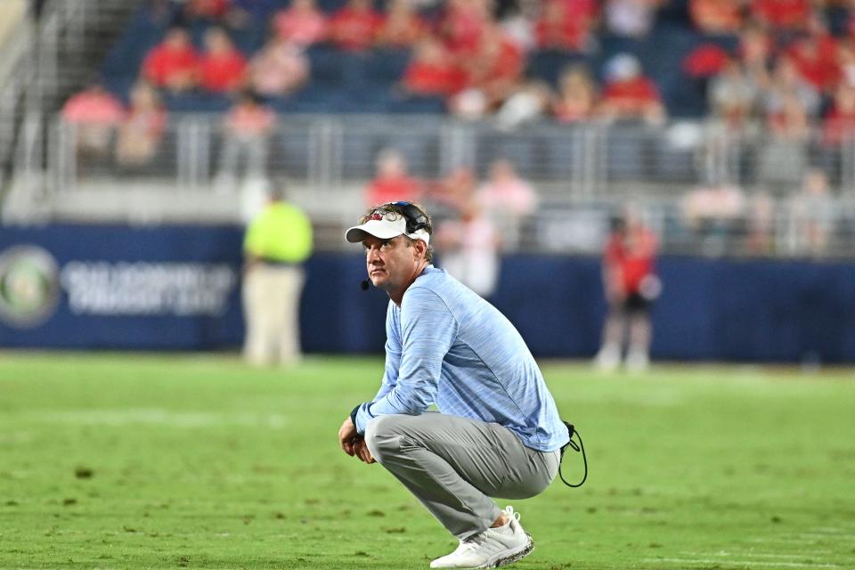 Lane Kiffin looks at the scoreboard during a timeout against the Central Arkansas Bears during the second quarter at Vaught-Hemingway Stadium.